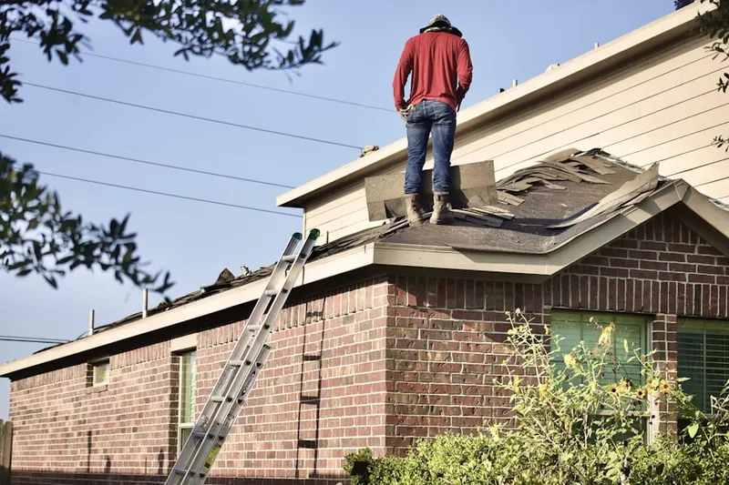 Professional roofer working on a residential roof in Woodfield Country Club